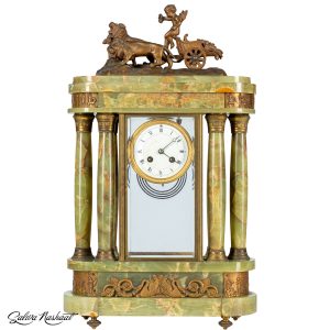 Clock with lions and a angel figurine on top